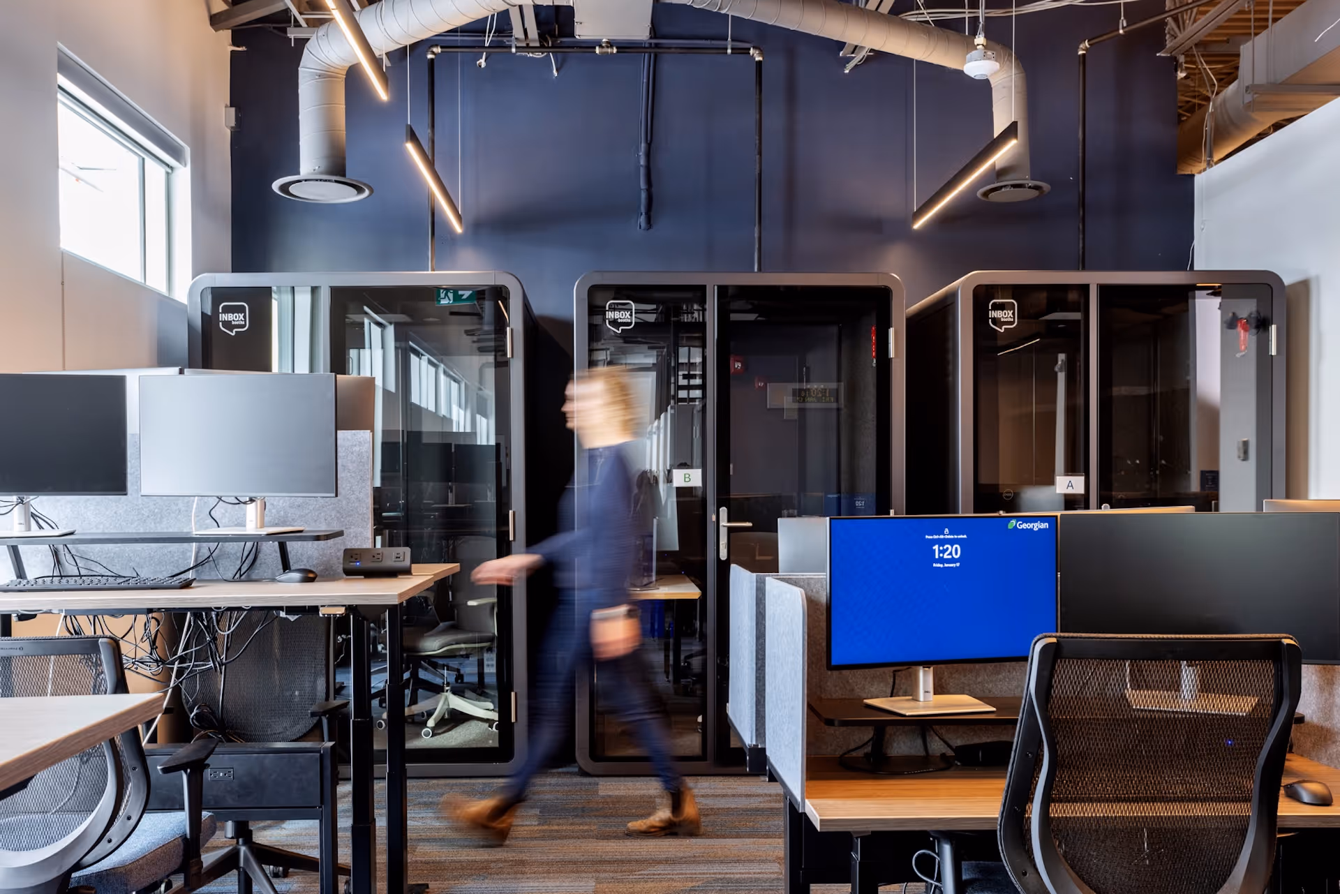person walking through interior open concept office