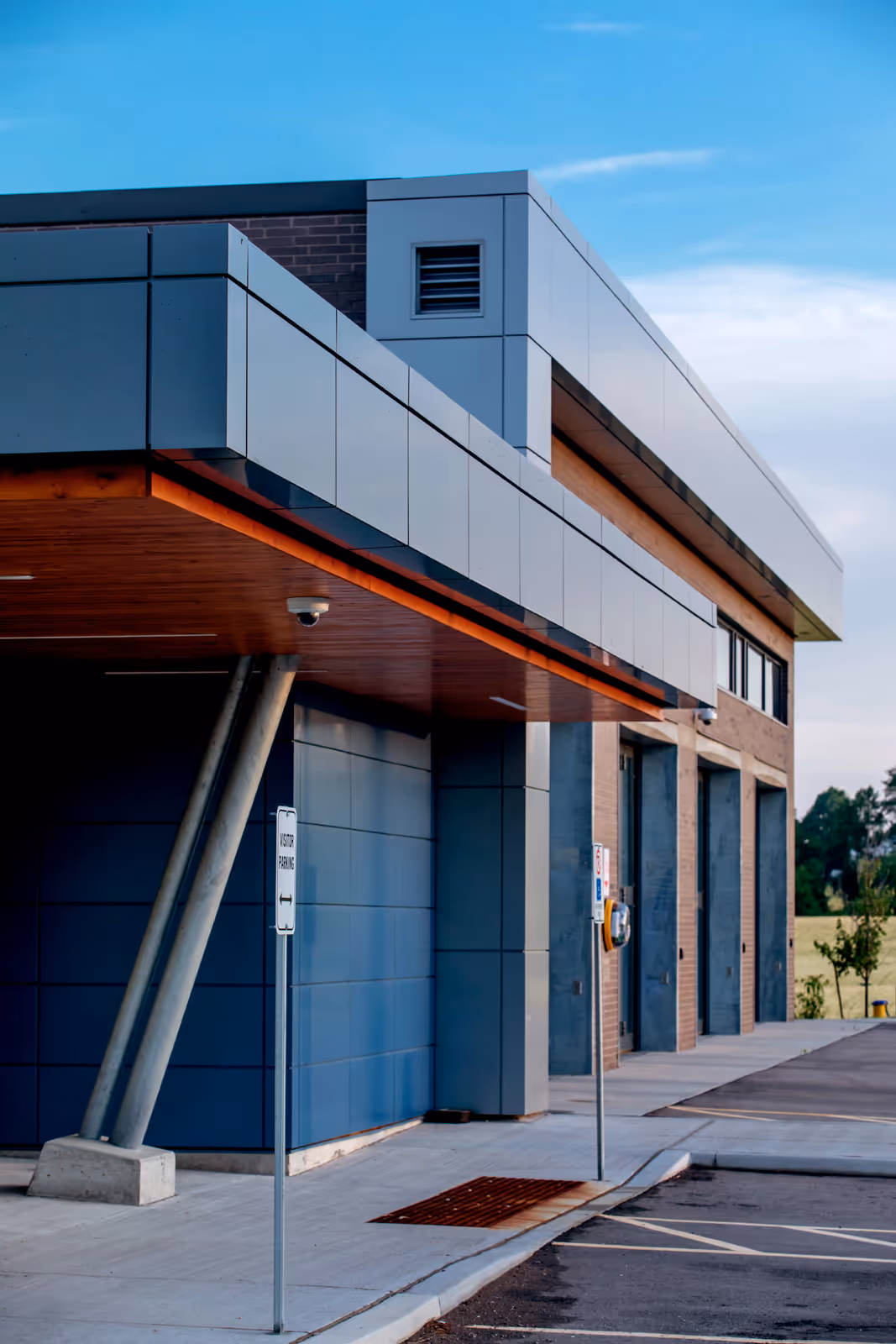 Exterior detail of York Paramedic Station showing angled steel column supports, metal cladding, and garage bay entrances.