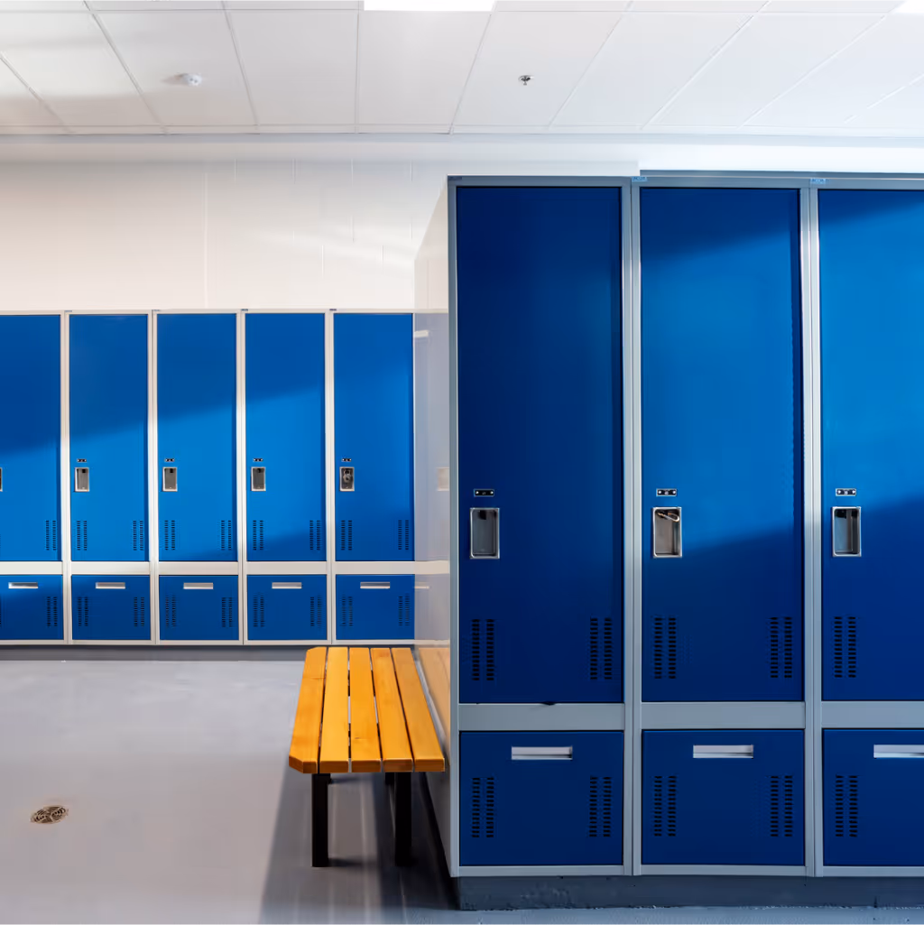 Locker room interior with bright blue lockers and a wooden bench under fluorescent lighting.