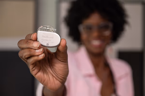 Woman holding the Interstim device