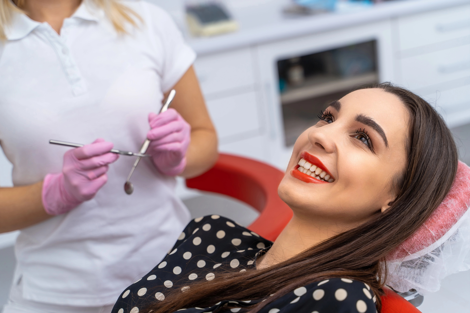 woman smiling while visiting the best dentist in Somerville