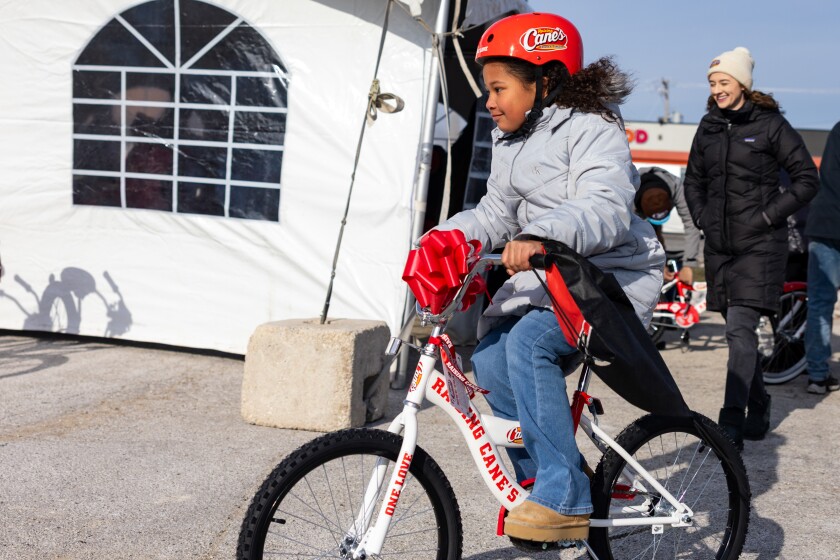 Penelope rides her new bike donated by Chance the Rapper’s nonprofit, SocialWorks, in partnership with Raising Cane’s on the Far South Side, Monday, Dec. 15, 2025.