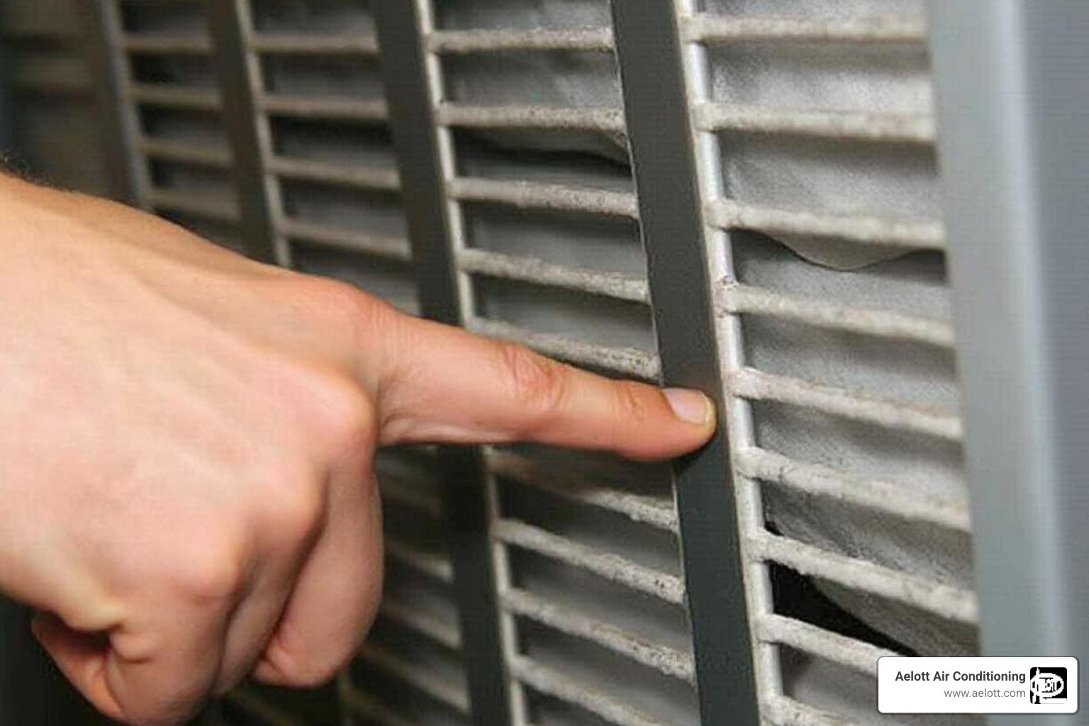 Person pointing to an HVAC filter slot - AC filter replacement
