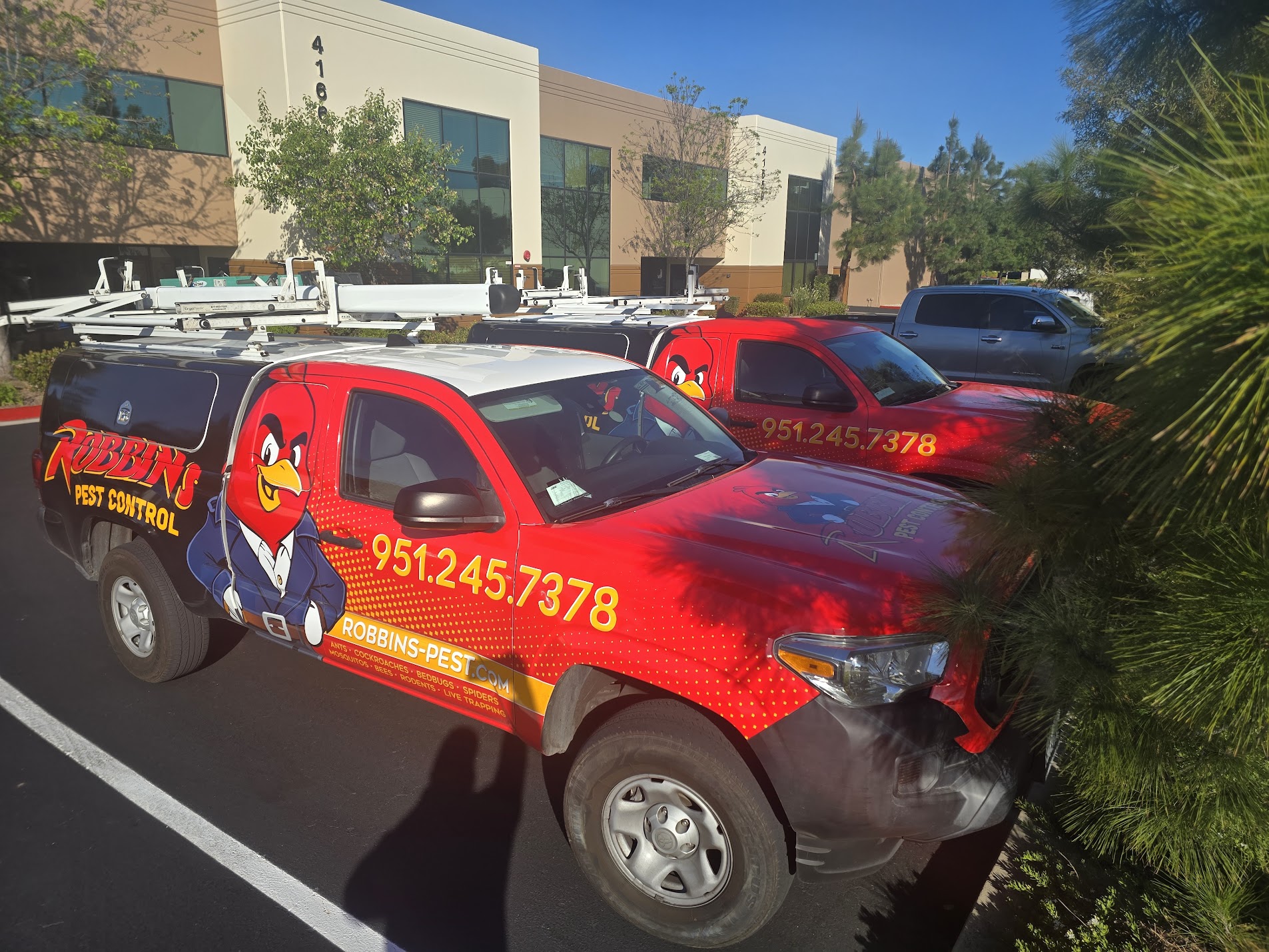 Commercial pest control service trucks parked at office property in Temecula CA