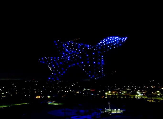 Dove drone light show formation in the night sky