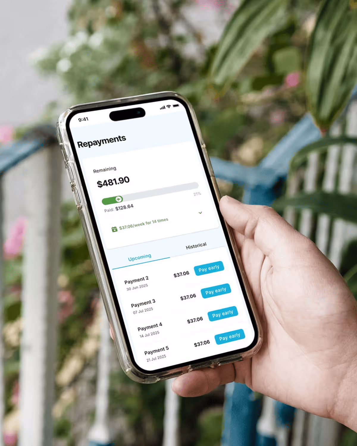 Image of a hand holding a phone with a mockup of the repayment dashboad