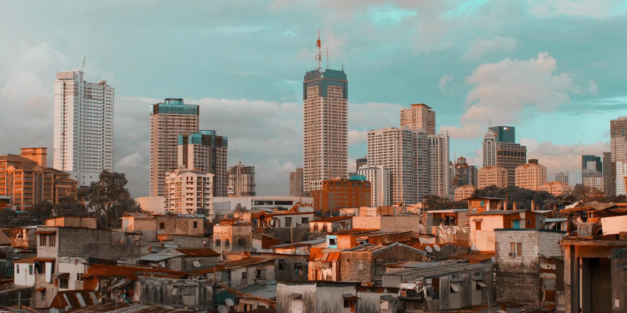 Metro Manila city skyline under a blue sky in daylight