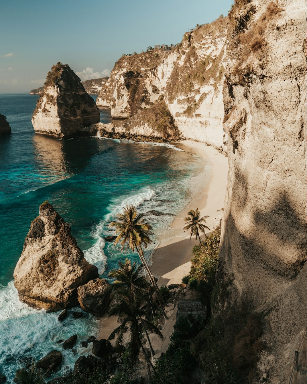 Limestone cliffs, rock formations and turquoise water at a beach on Nusa Penida, a short boat ride from Bali.