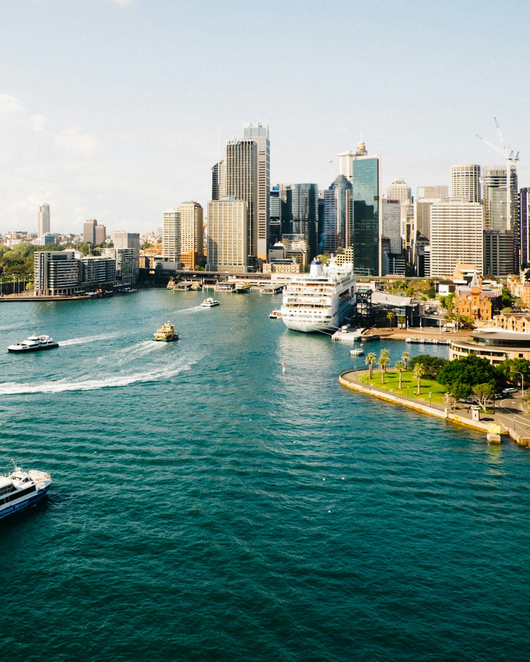 Ferries crossing Sydney Harbour in front of the city skyline at Circular Quay.