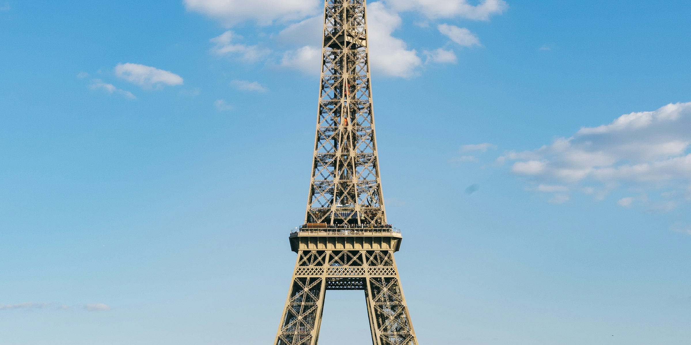 Eiffel Tower in Paris under dramatic clouds in daylight