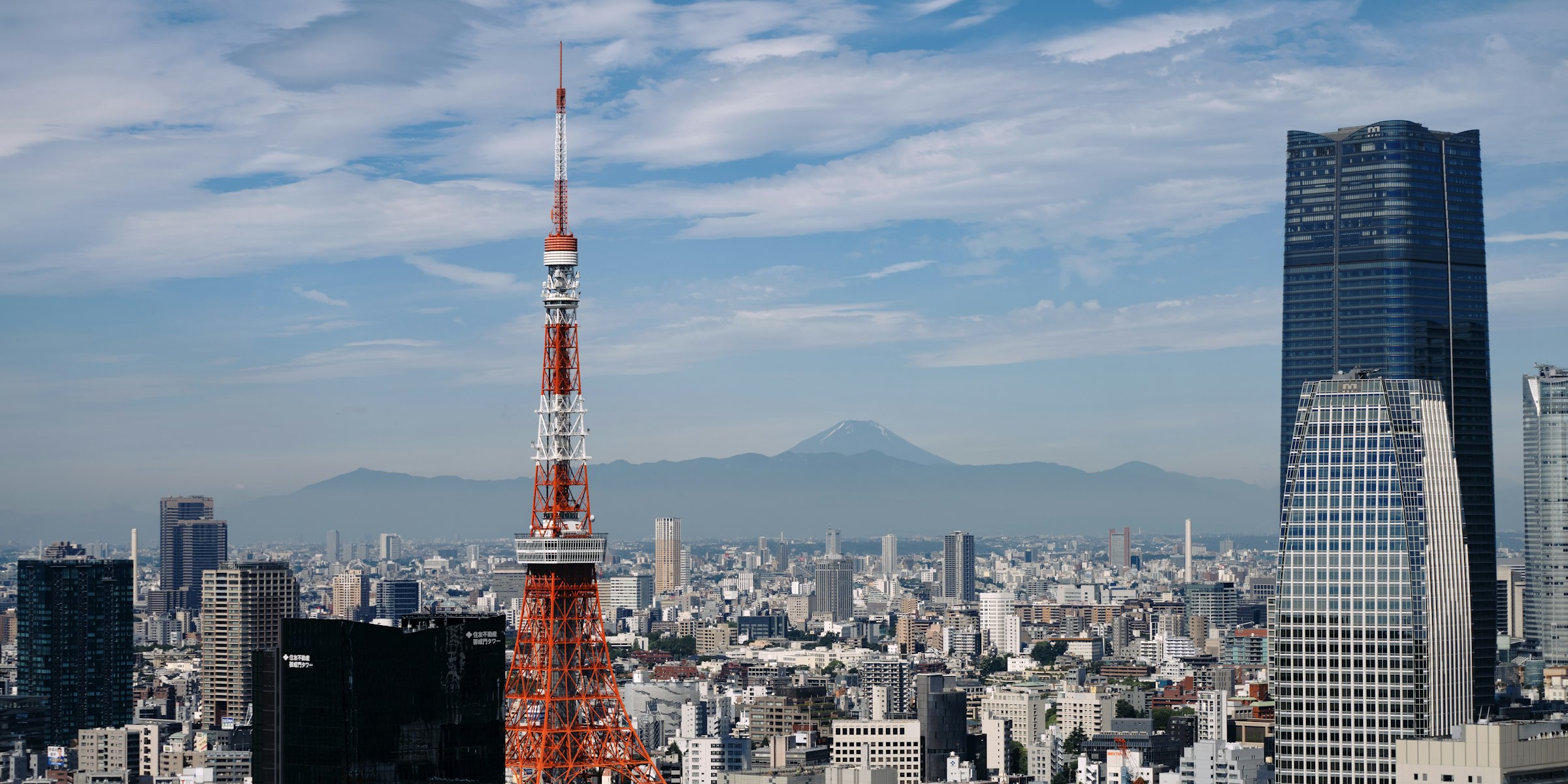 Tokyo Tower rising above the Tokyo skyline in daylight