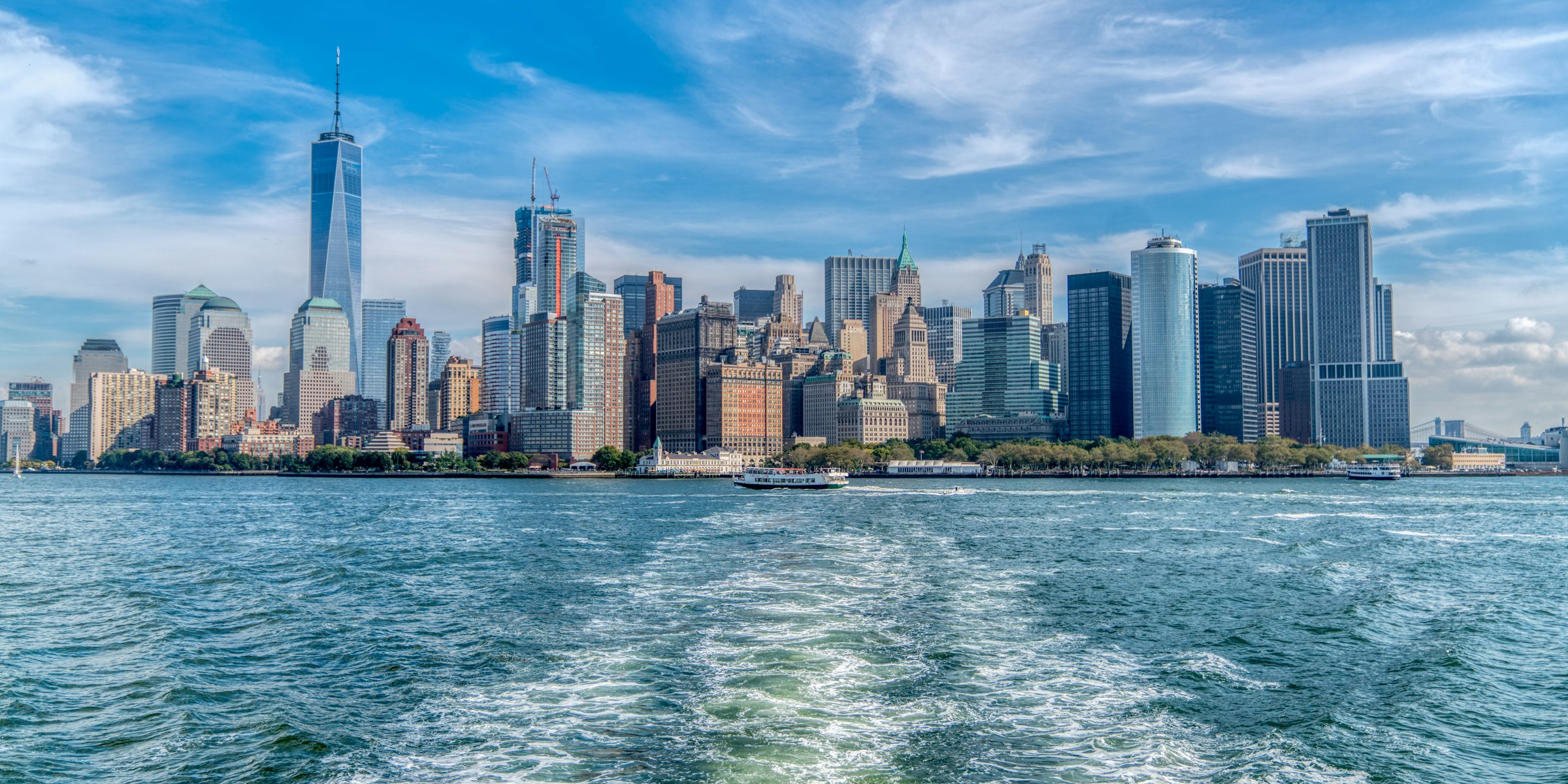 Lower Manhattan skyline across the harbour on a sunny day