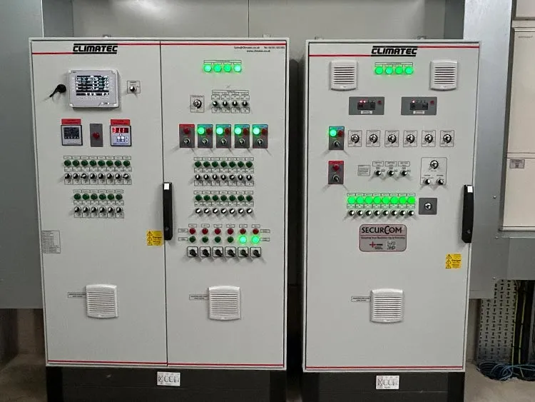 Two ClimaTEC industrial control panels with multiple green indicator lights, switches, and displays.