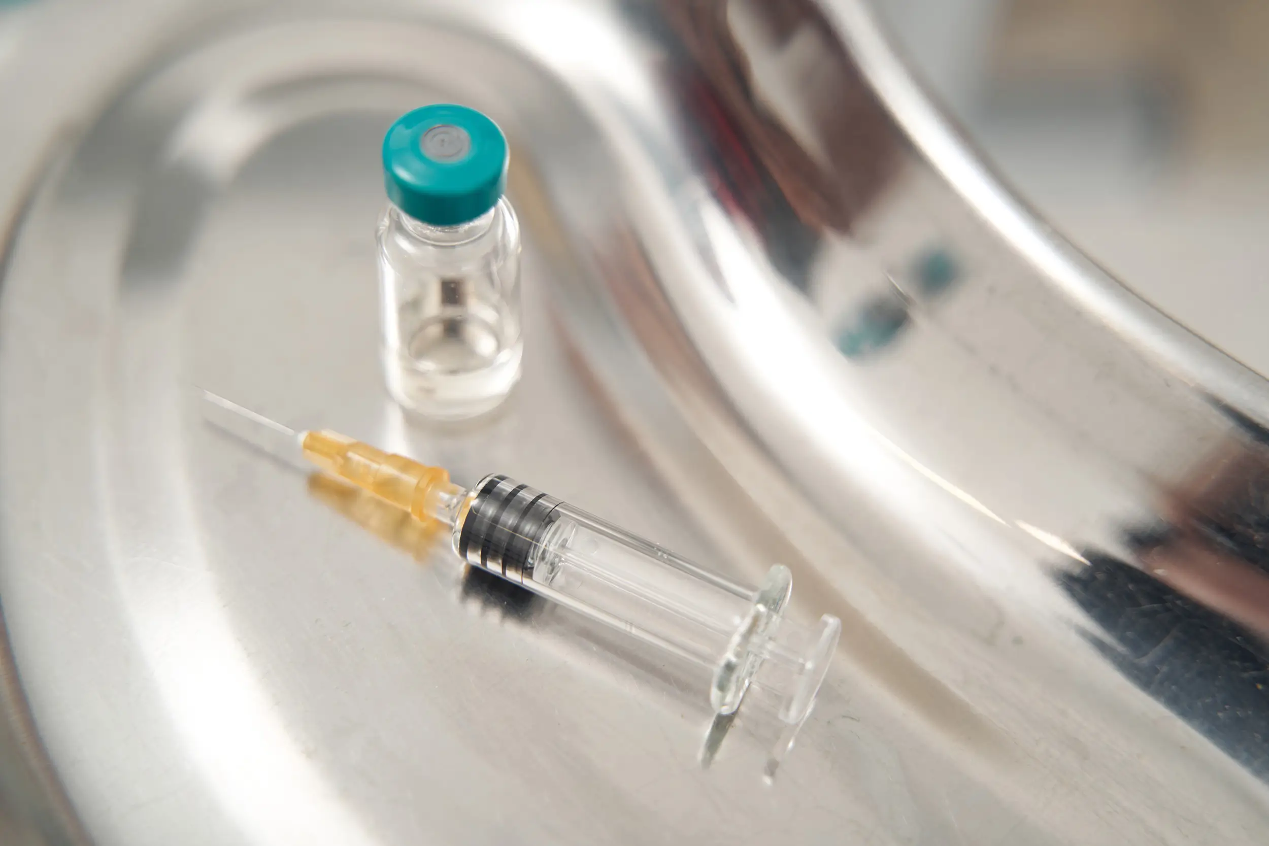 Syringe with liquid laying on the table before procedure