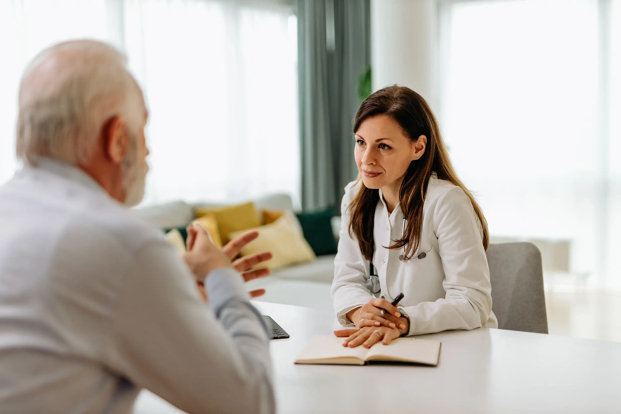 Doctor talking to her patient in office