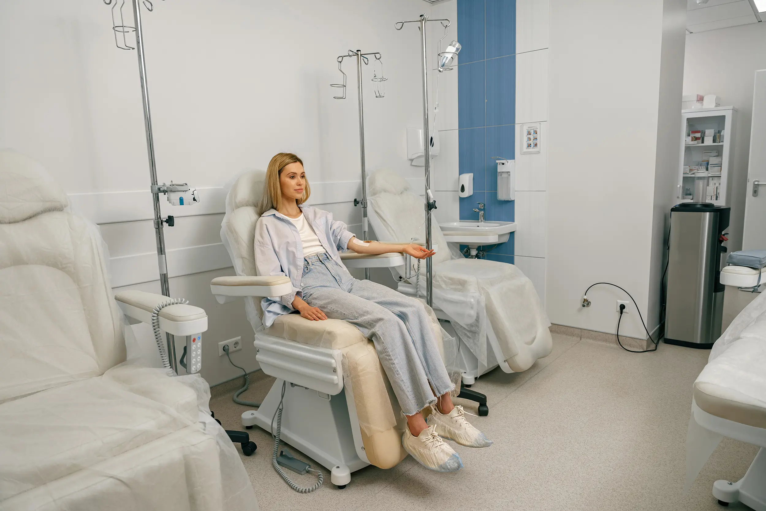 Female patient sitting with IV drip connected
