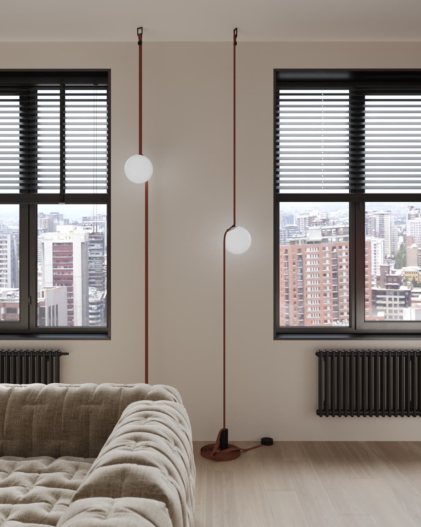 Pendant lighting detail with leather cord and frosted globe bulbs beside tufted beige sofa in modern apartment
