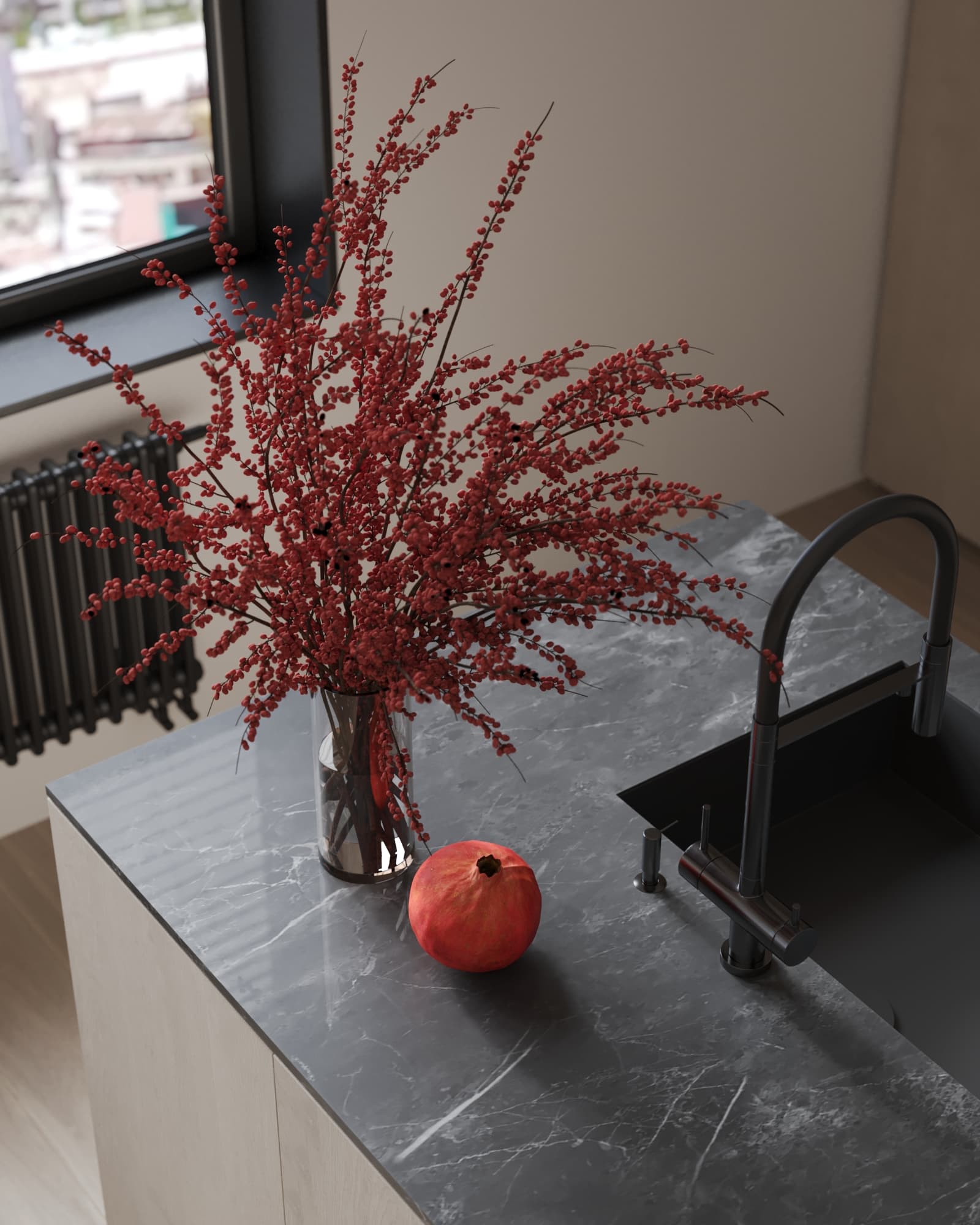 Dark marble kitchen island with black sink, red floral arrangement, and a pomegranate adding contrast and elegance