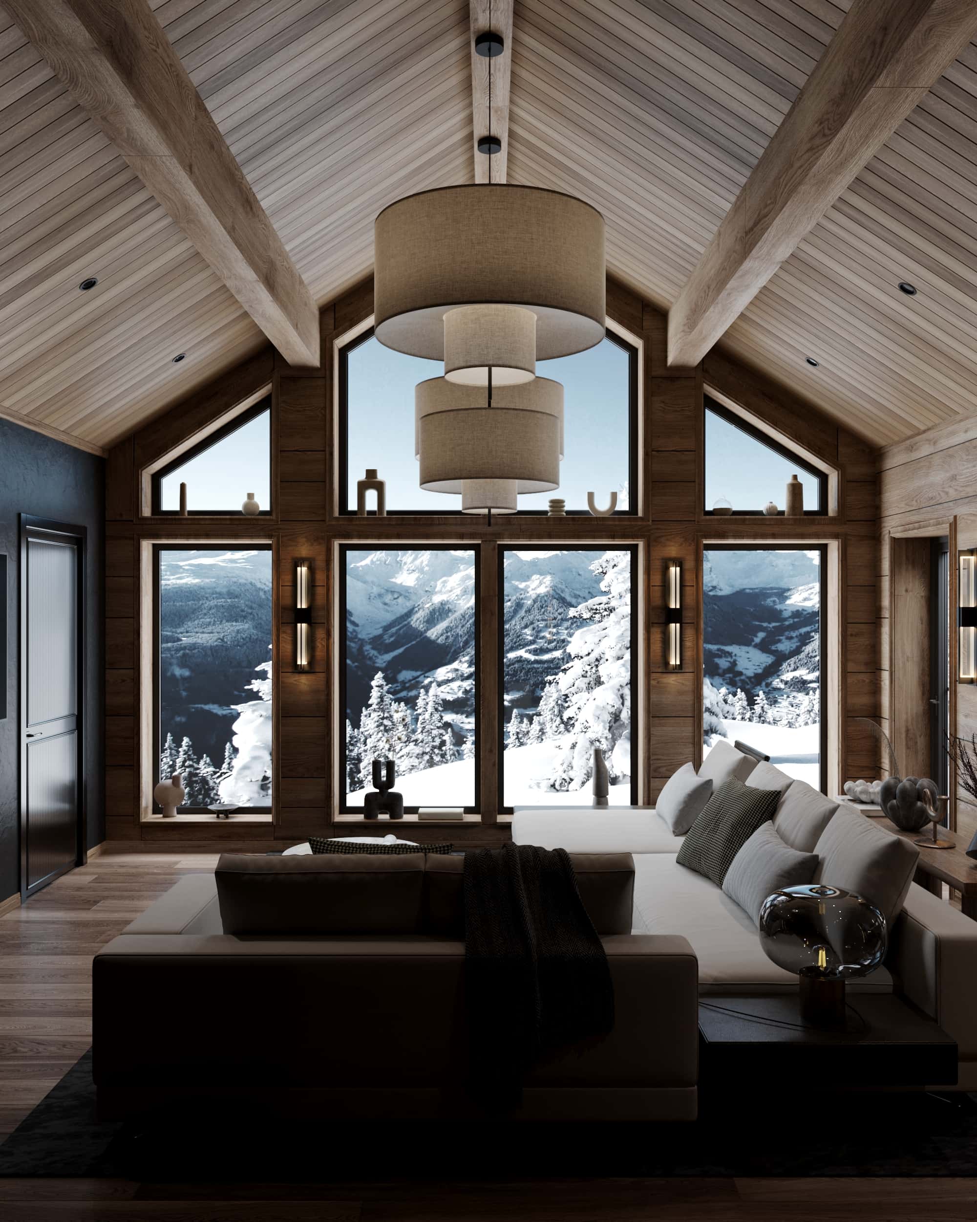 Cozy chalet living room with vaulted wood ceiling, large windows, and panoramic view of the snowy French Alps