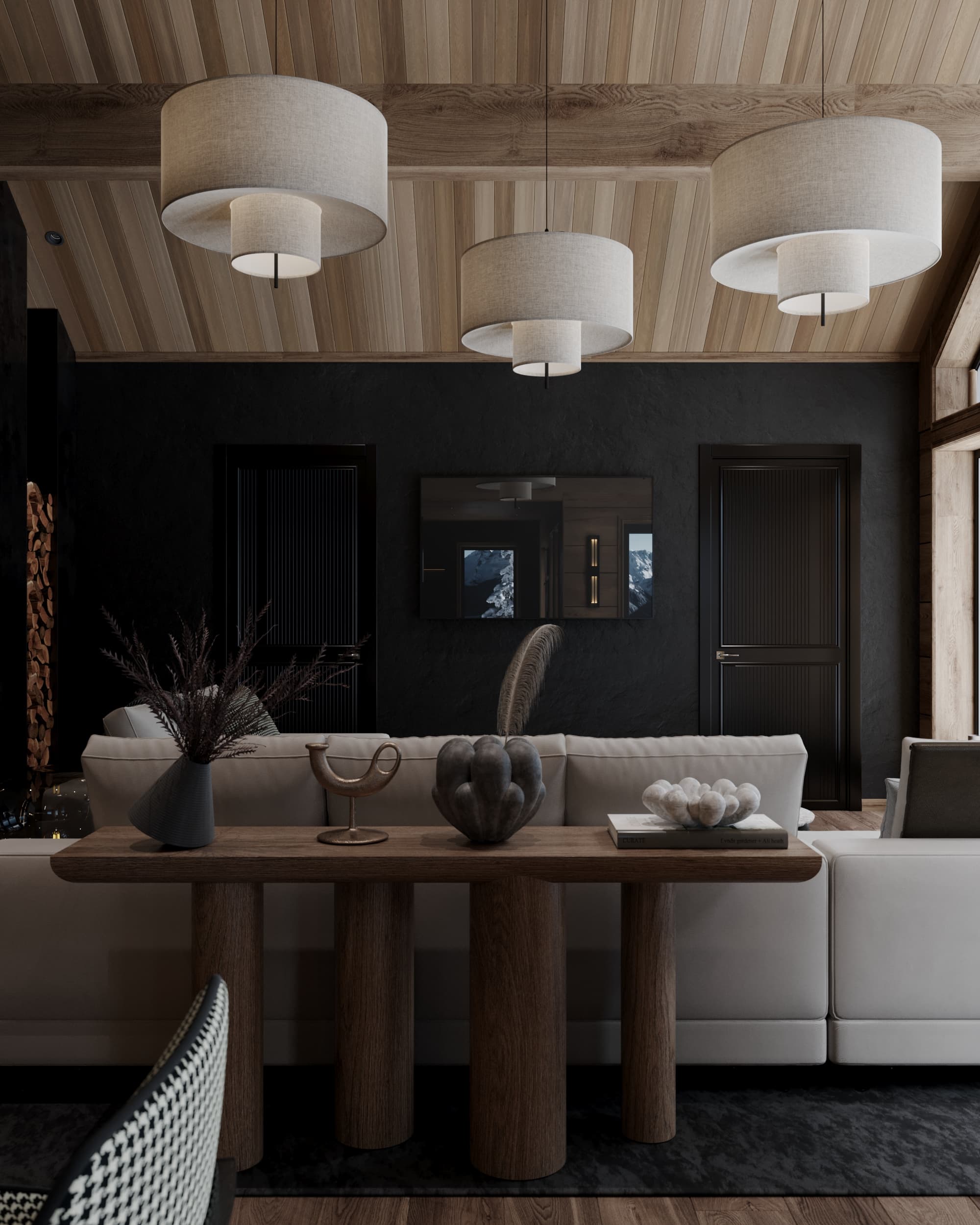 Back view of a cozy chalet living room featuring a wood console table with artistic decor and pendant lighting under a vaulted ceiling