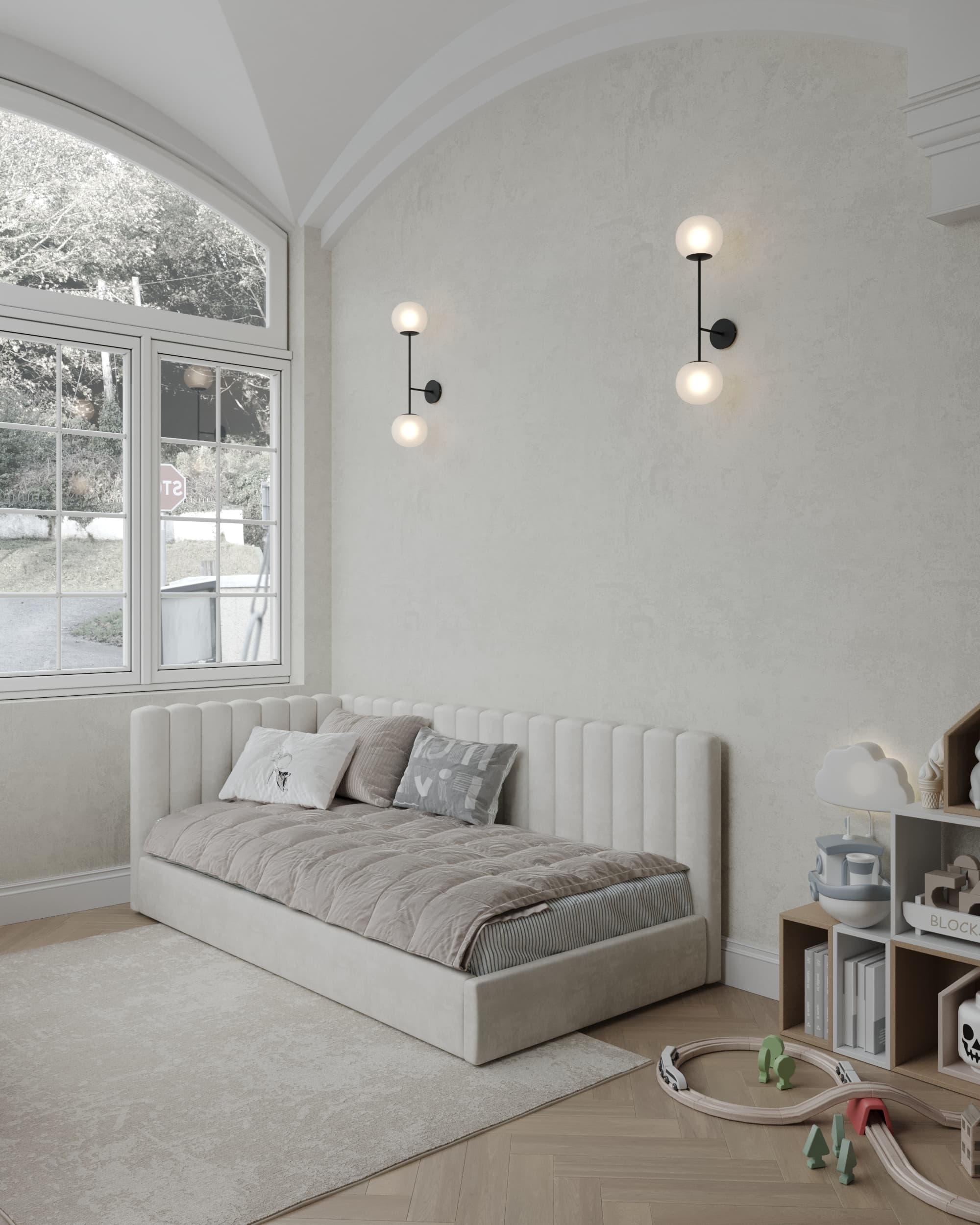 Children’s room with a cozy upholstered daybed, arched ceiling, soft lighting, and a wooden toy train set