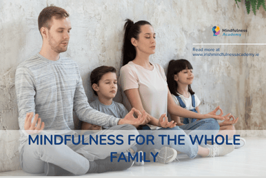 A family sitting together, practicing a moment of stillness 