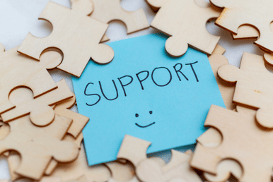 A poster showing a note of support in the middle, surrounded by puzzle pieces