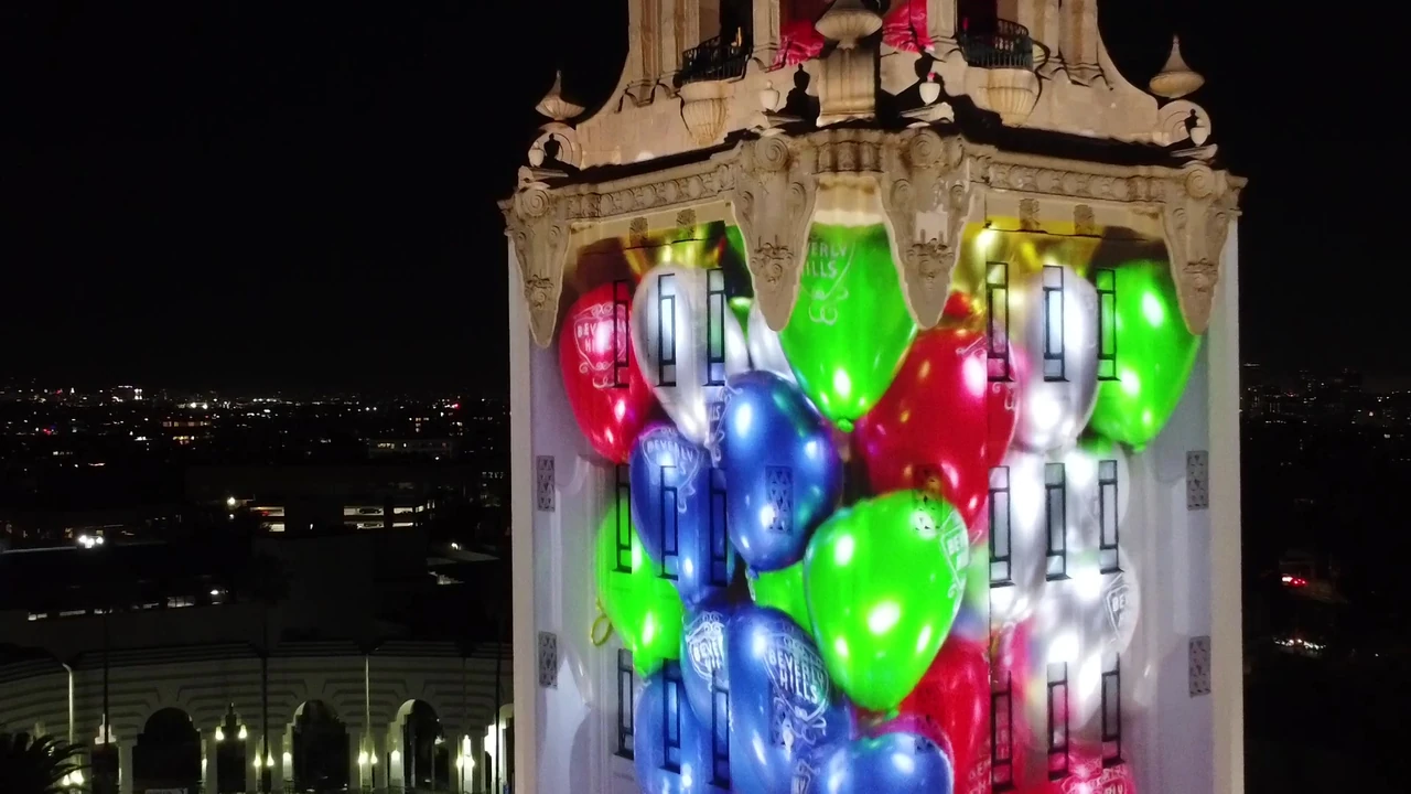 3D projection mapping illuminating a building facade at night