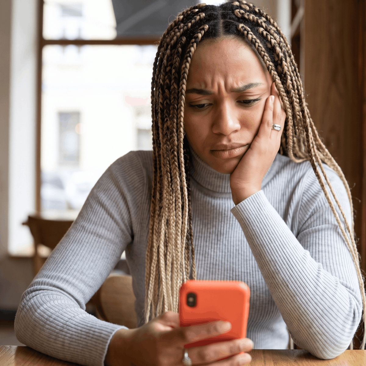 Candidate looking at her phone, waiting for a reply from an employer