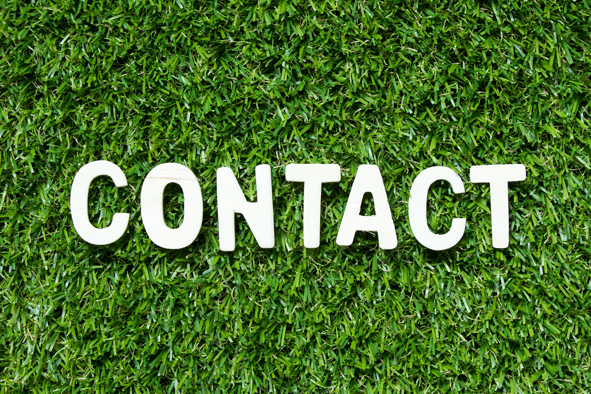Artificial Grass with the word Contact