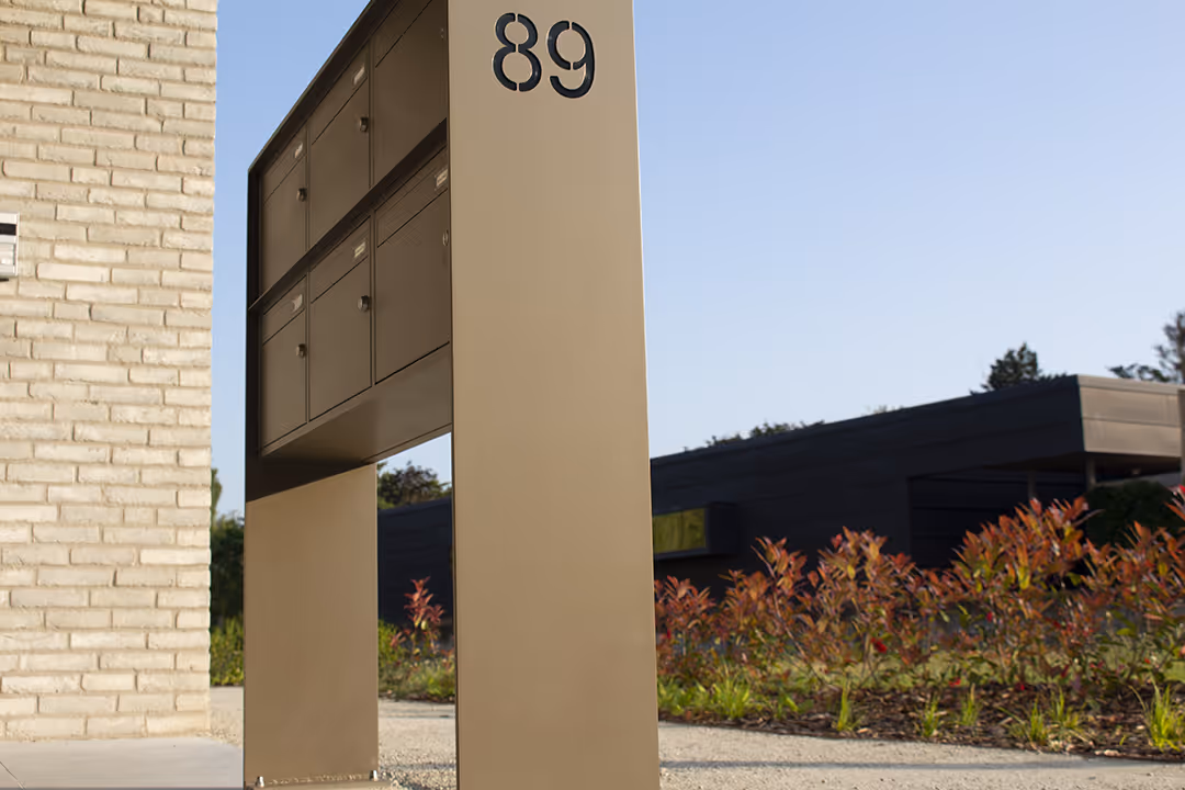 Une boîte aux lettres beige clair portant le numéro 89.