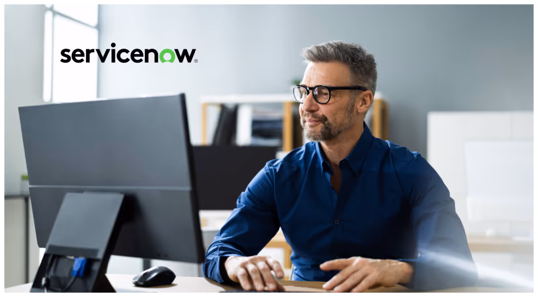 Photo of man working at a computer with the ServiceNow logo in the upper corner of the photo
