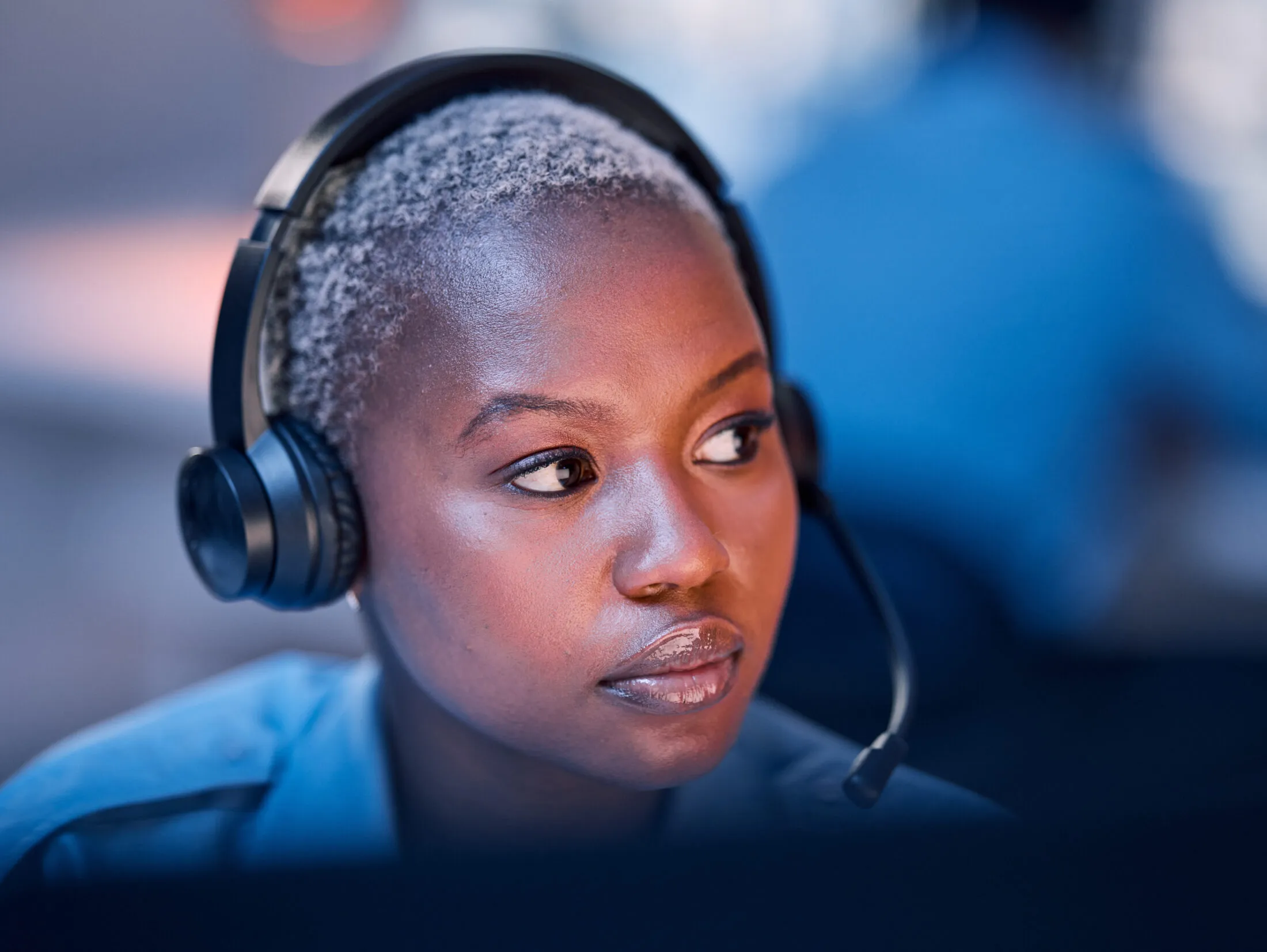 Close up of an emergency dispatcher wearing a phone headset.