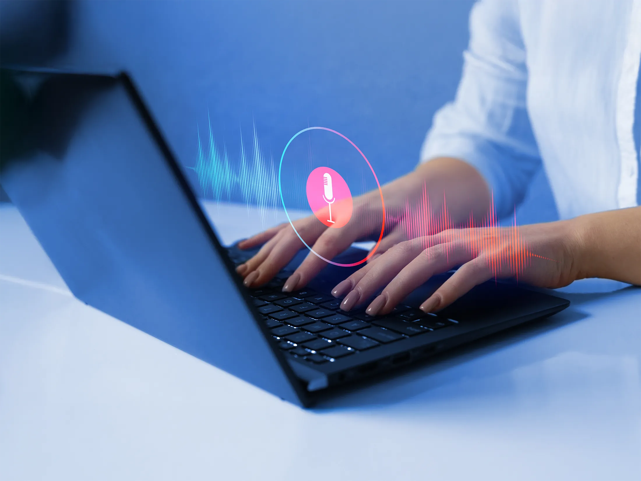 Close up of hands on a keyboard with a microphone icon overlaid on the photo.