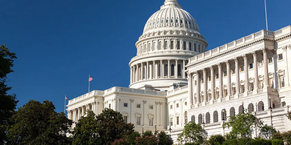 The U.S. Capitol building with an American flag in front of it.