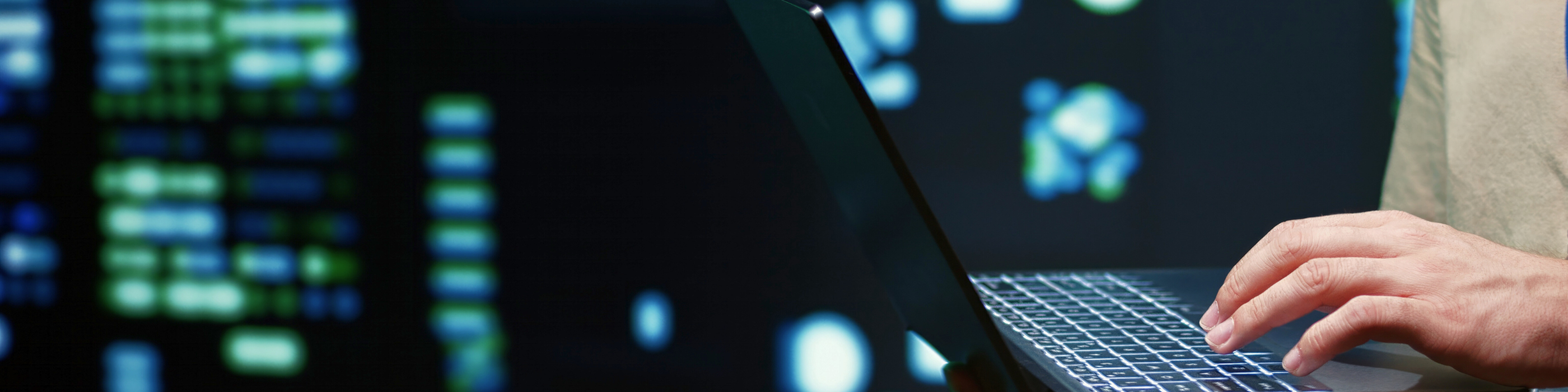 Close up of hands on a laptop keyboard.