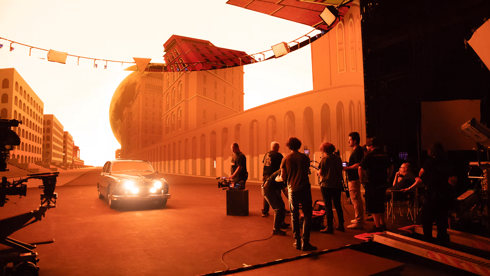 Crew filming inside UNSPACE LED volume lit orange, blending virtual palace facade with live-action actors.