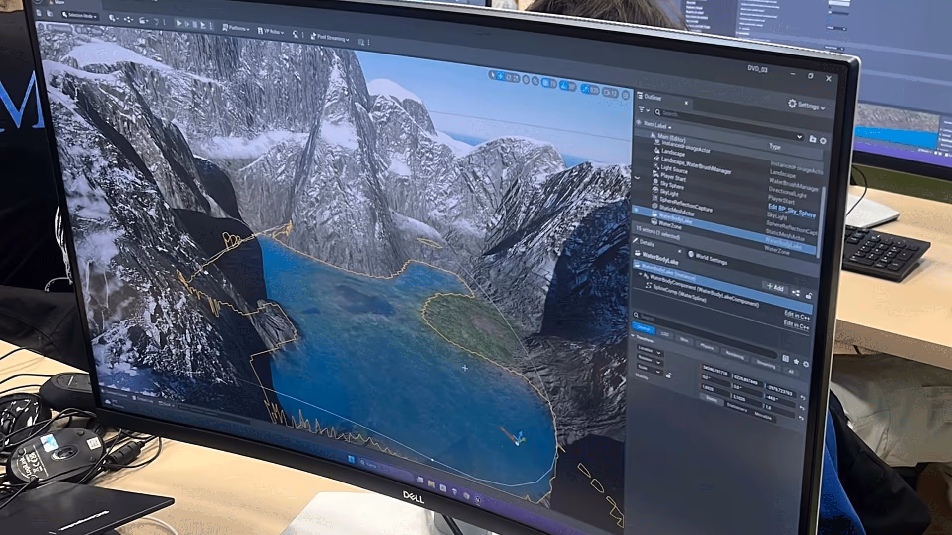 Dell monitor showing Unreal Engine mountain environment during UNSPACE.design-lab training session.