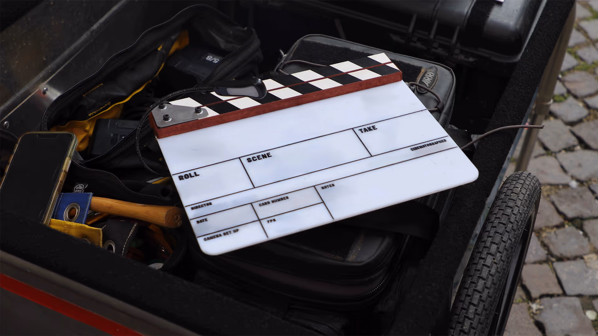 Empty film slate resting on gear cart before UNSPACE Turin virtual-production shoot.`