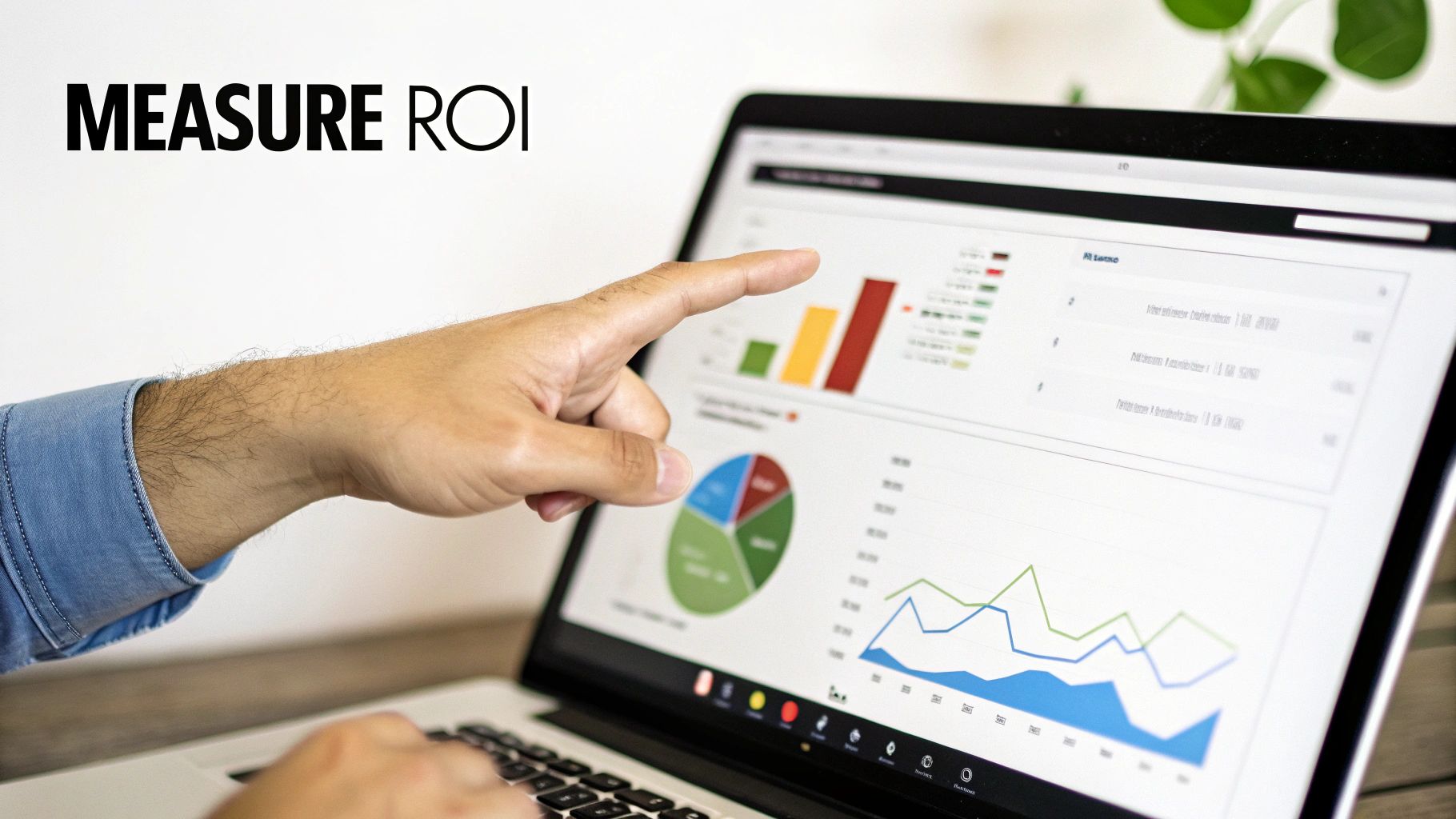 A person's hand points at a laptop displaying colorful business data charts and graphs, emphasizing measuring ROI.