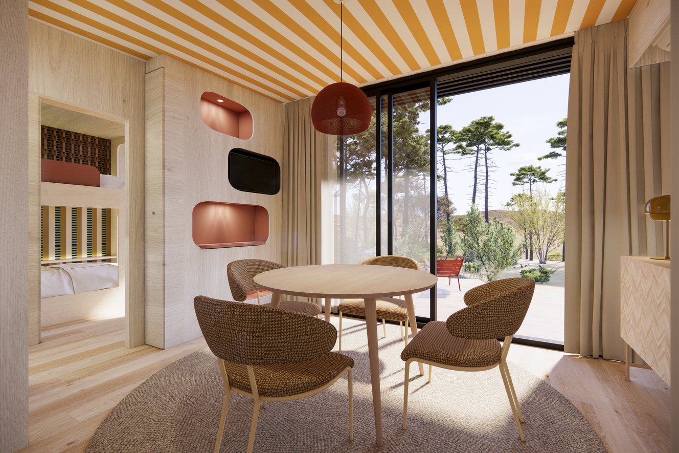 Leefruimte met tafel, stoelen en uitzicht naar buiten door een erker vanuit de Mini Villa van Bonjour Sauvage