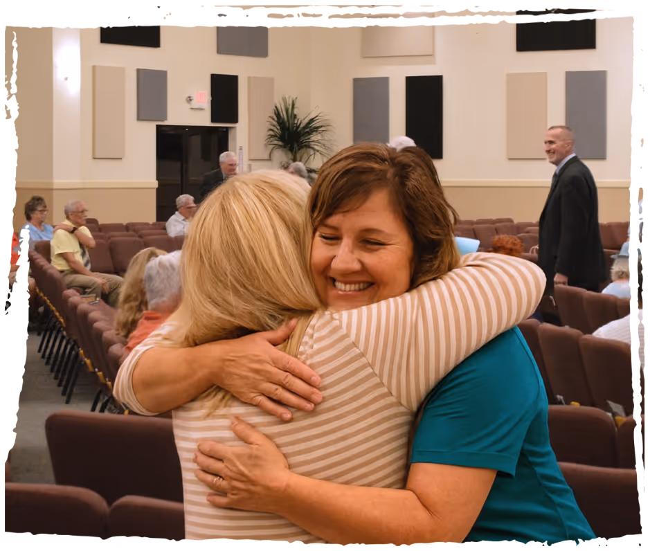 Smiling church members greeting visitors with open arms at Colonial Oaks Baptist Church, embodying warmth and hospitality.