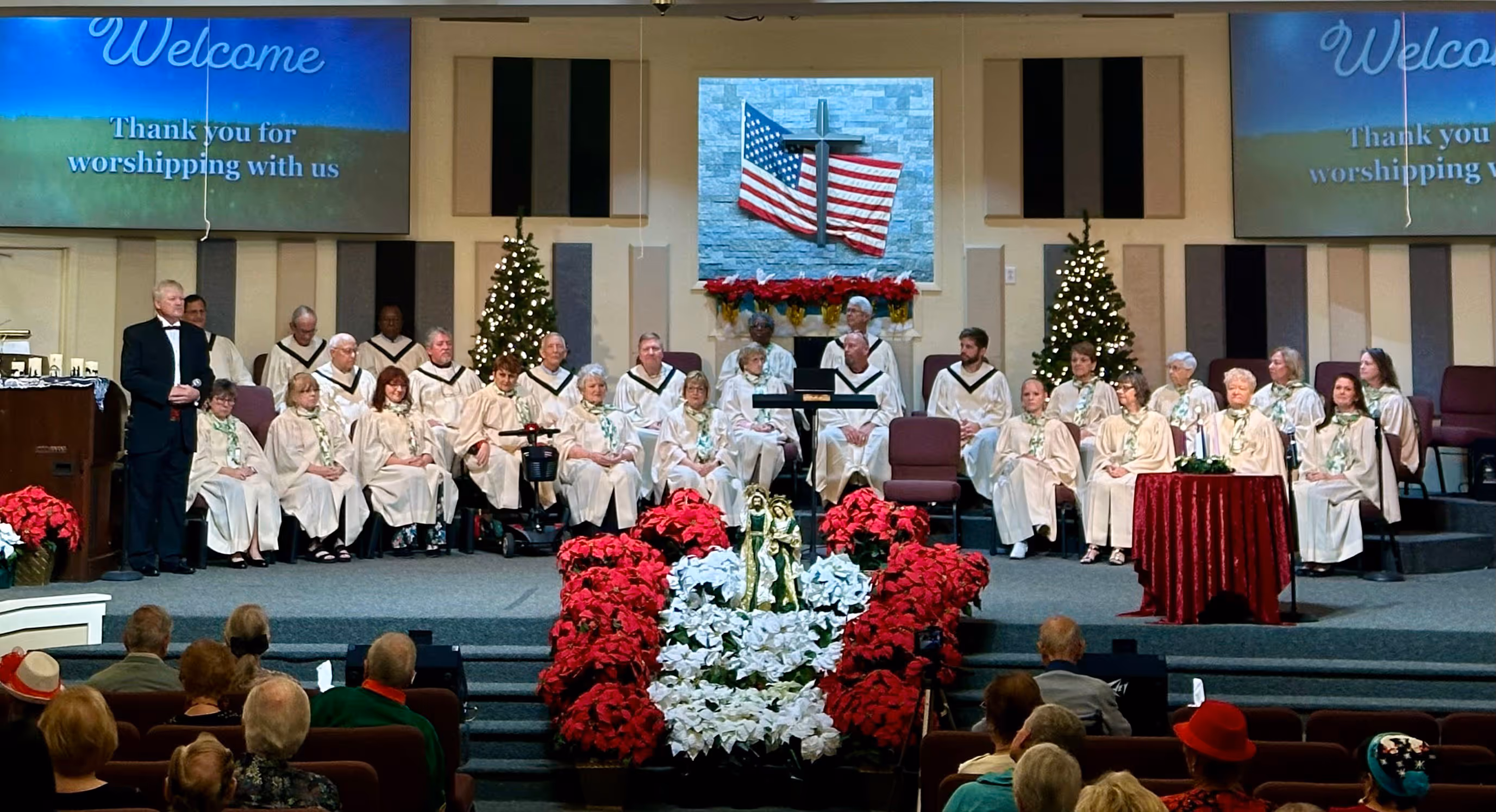 Adult choir singing joyfully during worship at Colonial Oaks Baptist Church, praising God through music and harmony.