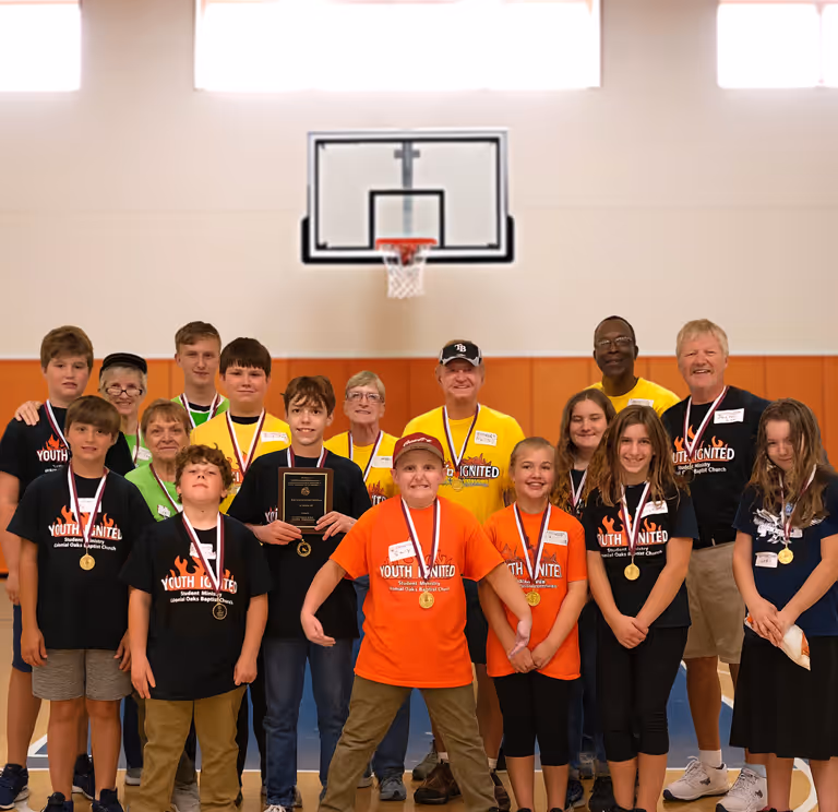 Teenagers worshiping and laughing together during Ignite Youth at Colonial Oaks Baptist Church, growing in faith and friendship.