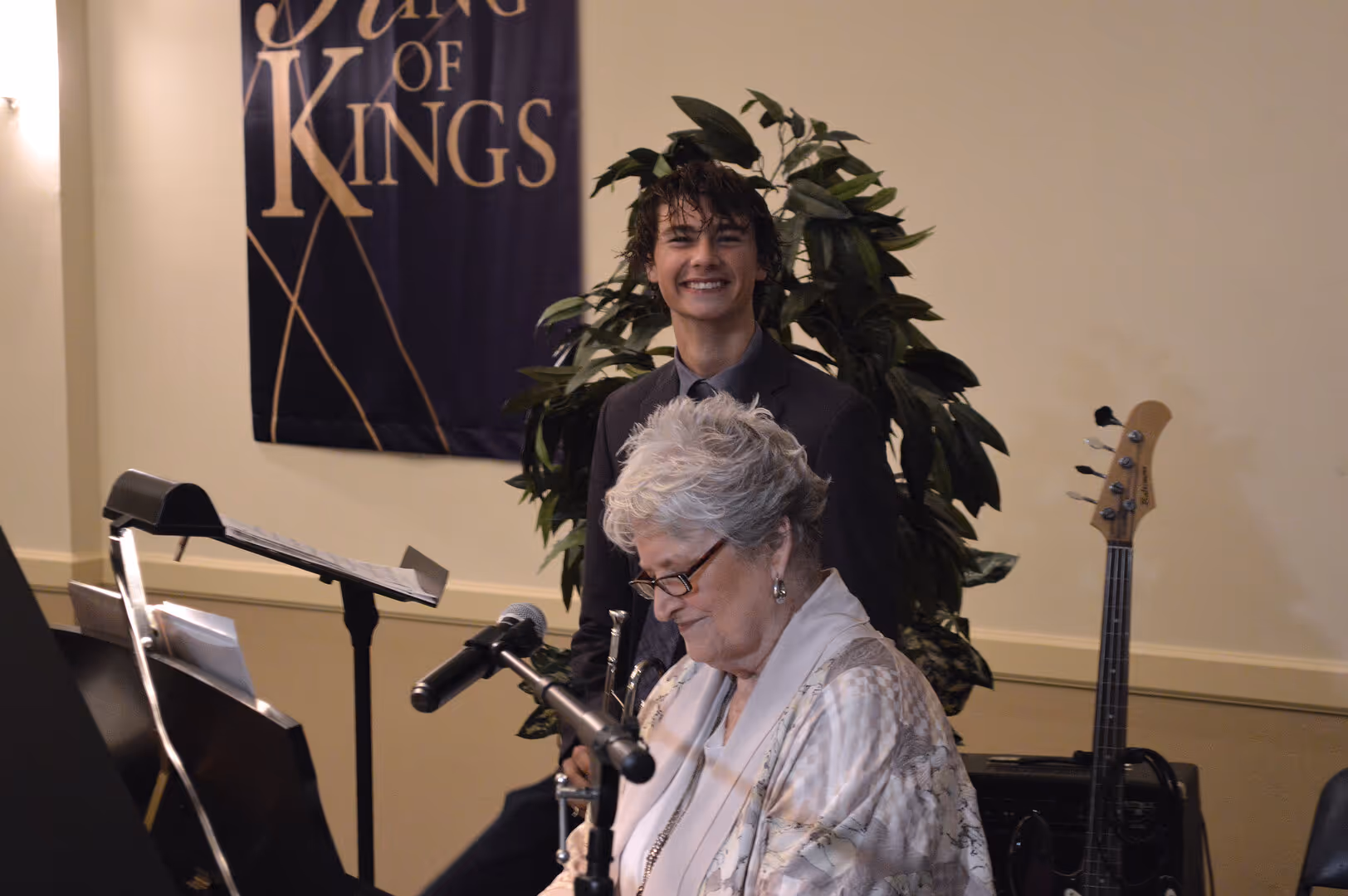 Members of Colonial Oaks Baptist Church smiling and talking together, representing community involvement and fellowship in a warm, welcoming environment.