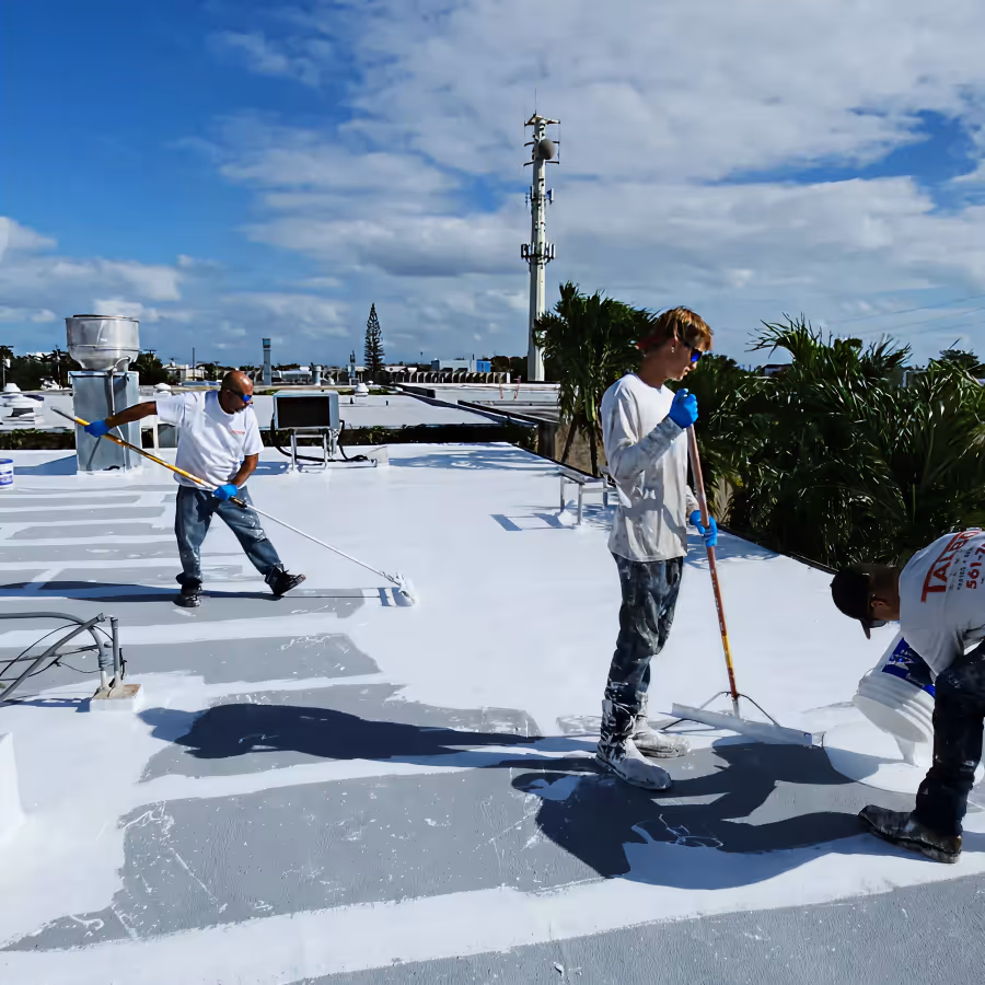 workers rolling on a commercial flat roof coating