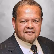 A person in a suit and tieAI-generated content may be incorrect.