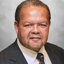 A person in a suit and tieAI-generated content may be incorrect.