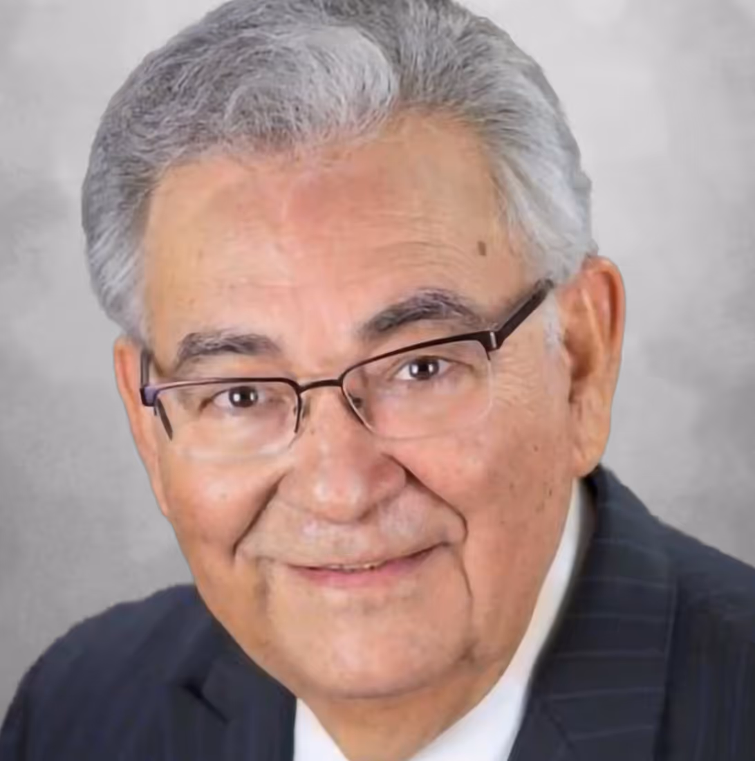 Picture of Rudy Rodriguez, an older man with grey hair and glasses