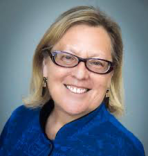 Laurie Olsen - a blonde woman with glasses and a blue shirt.